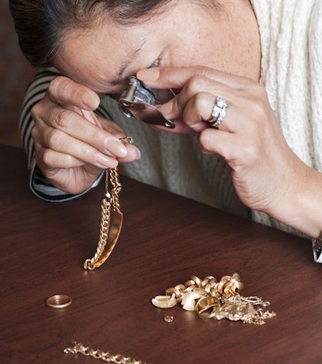 An person appraising jewelry items.