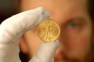 An appraiser inspecting a gold coin.